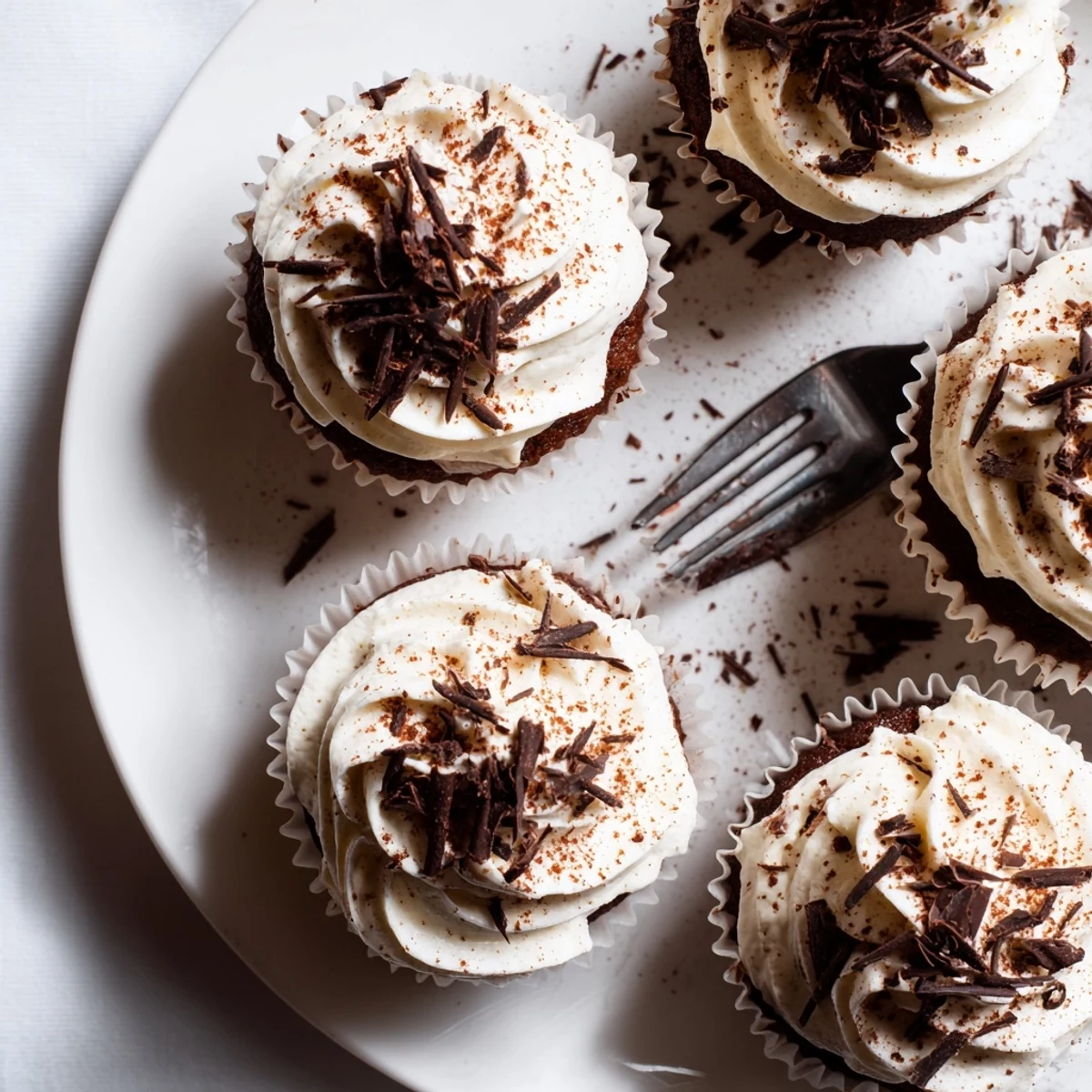 Decadent chocolate tiramisu cupcakes topped with fluffy mascarpone frosting and dusted cocoa powder