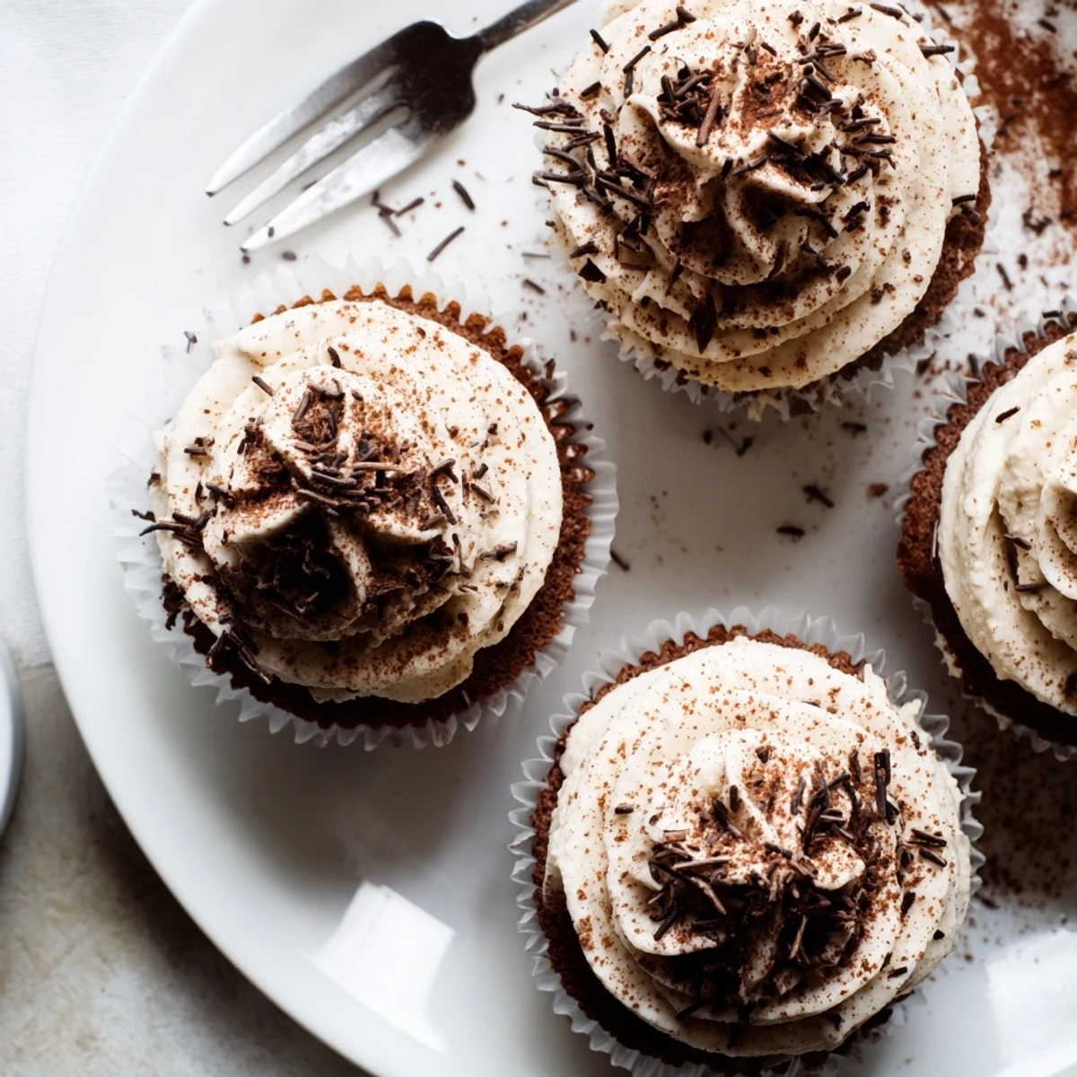 Chocolate tiramisu cupcakes swirled with sweet mascarpone cream and finished with dark chocolate shavings