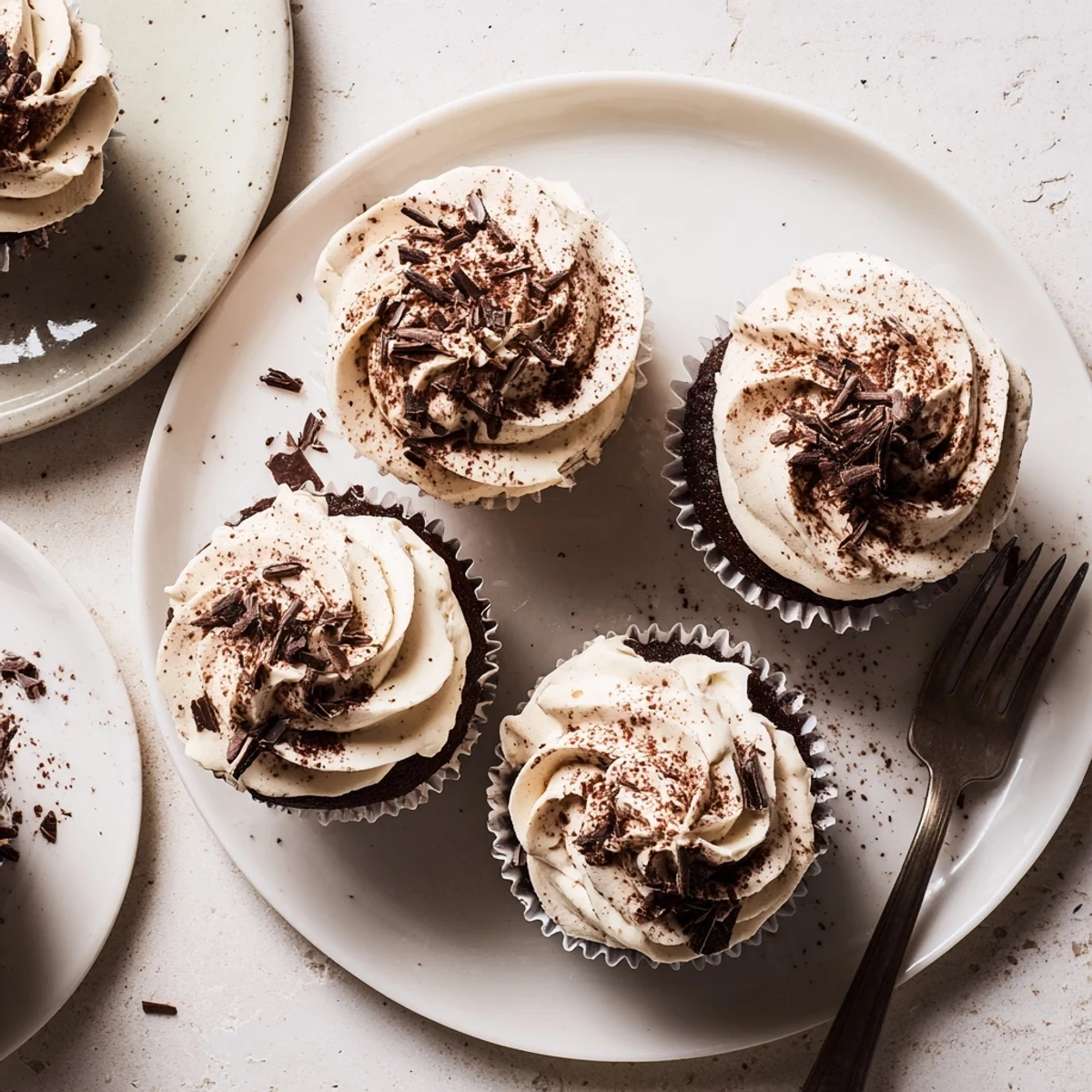 Rich chocolate cupcakes filled with coffee syrup and creamy Italian mascarpone frosting garnish
