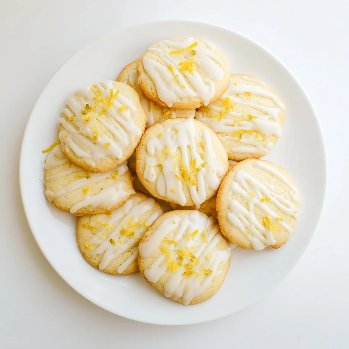 Soft Italian lemon cookies drizzled with Limoncello glaze arranged on a rustic wooden board for spring dessert.