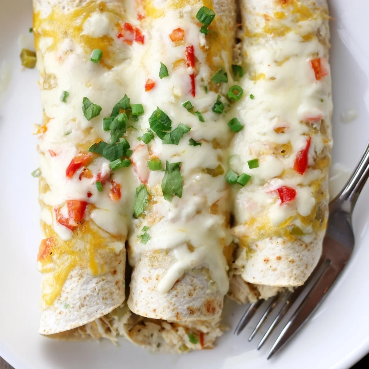 Oven-baked White Rotisserie Chicken Enchiladas, golden cheese crust and steaming, savory filling