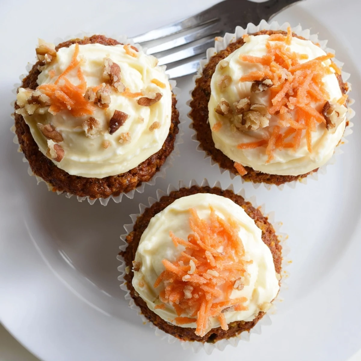 Freshly baked Moist Carrot Cake Cupcakes with crunchy walnuts and fluffy frosting.
