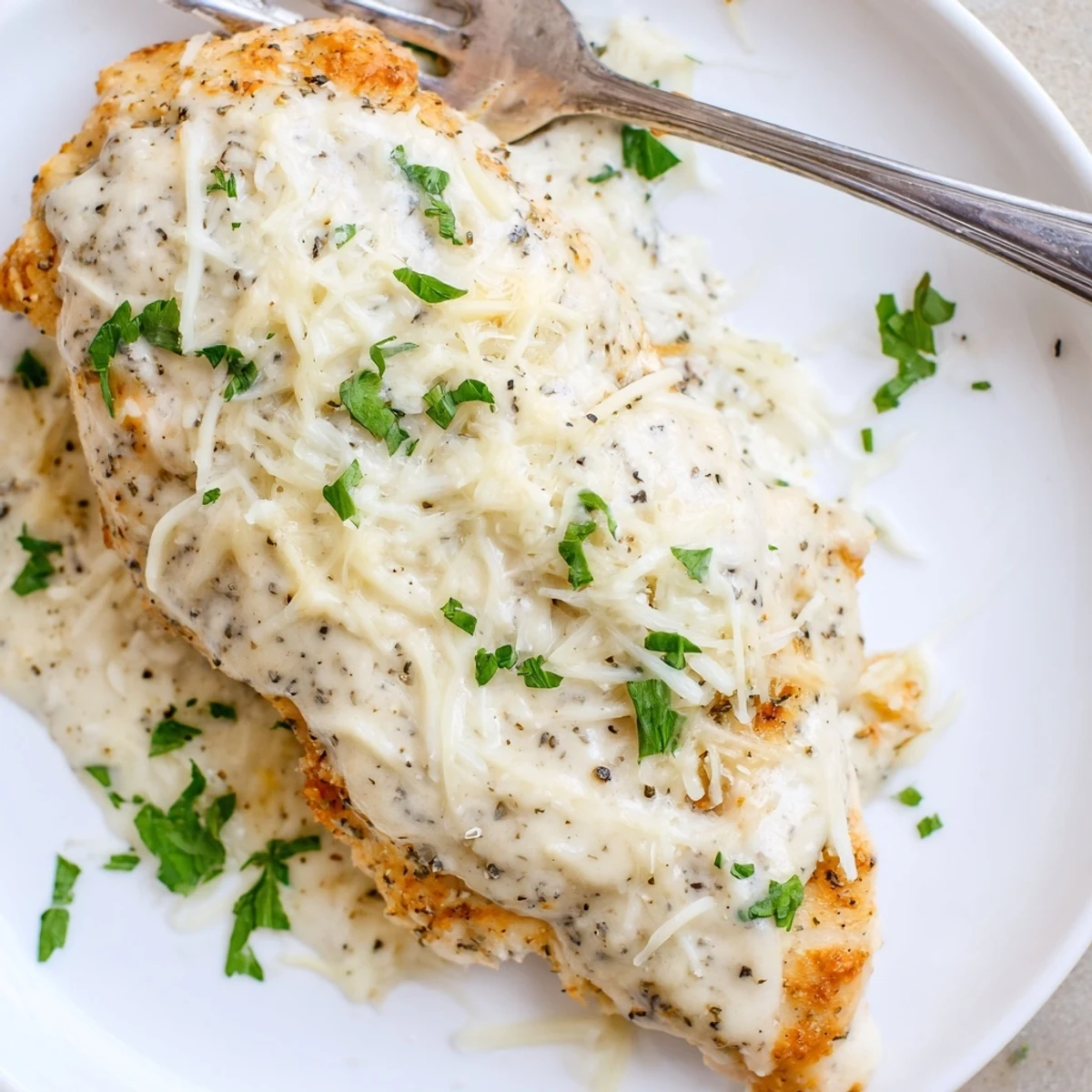 Savory Baked Caesar Chicken With Creamy Parmesan Sauce, rich garlic Parmesan aroma, parsley  