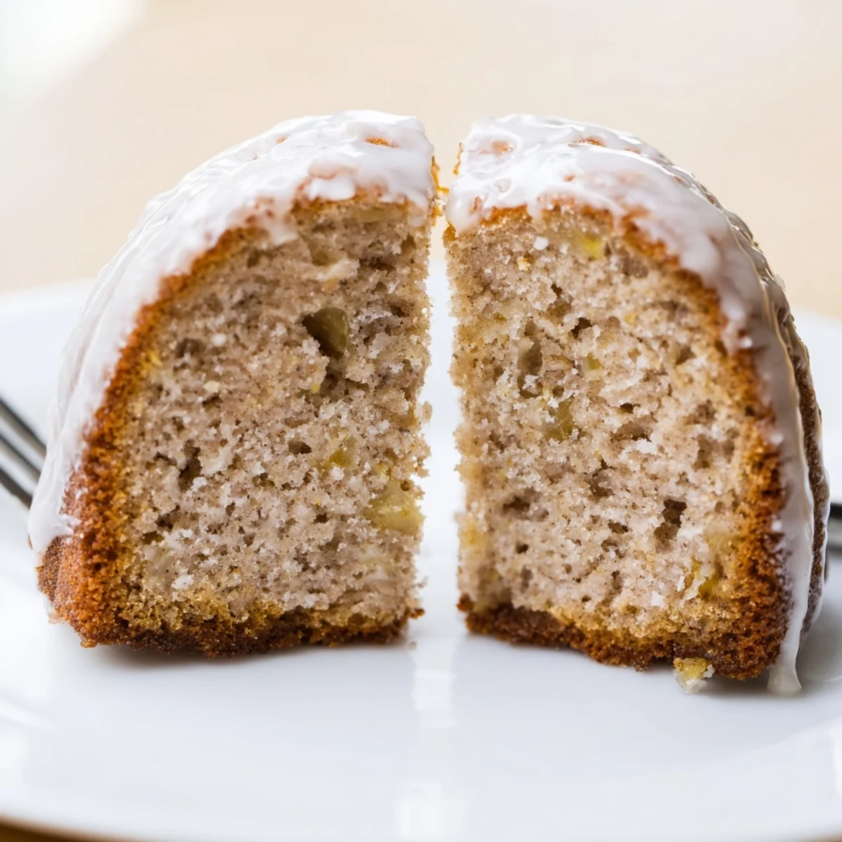 Warm Banana Donuts glistening with vanilla glaze, soft texture, sliced bananas.