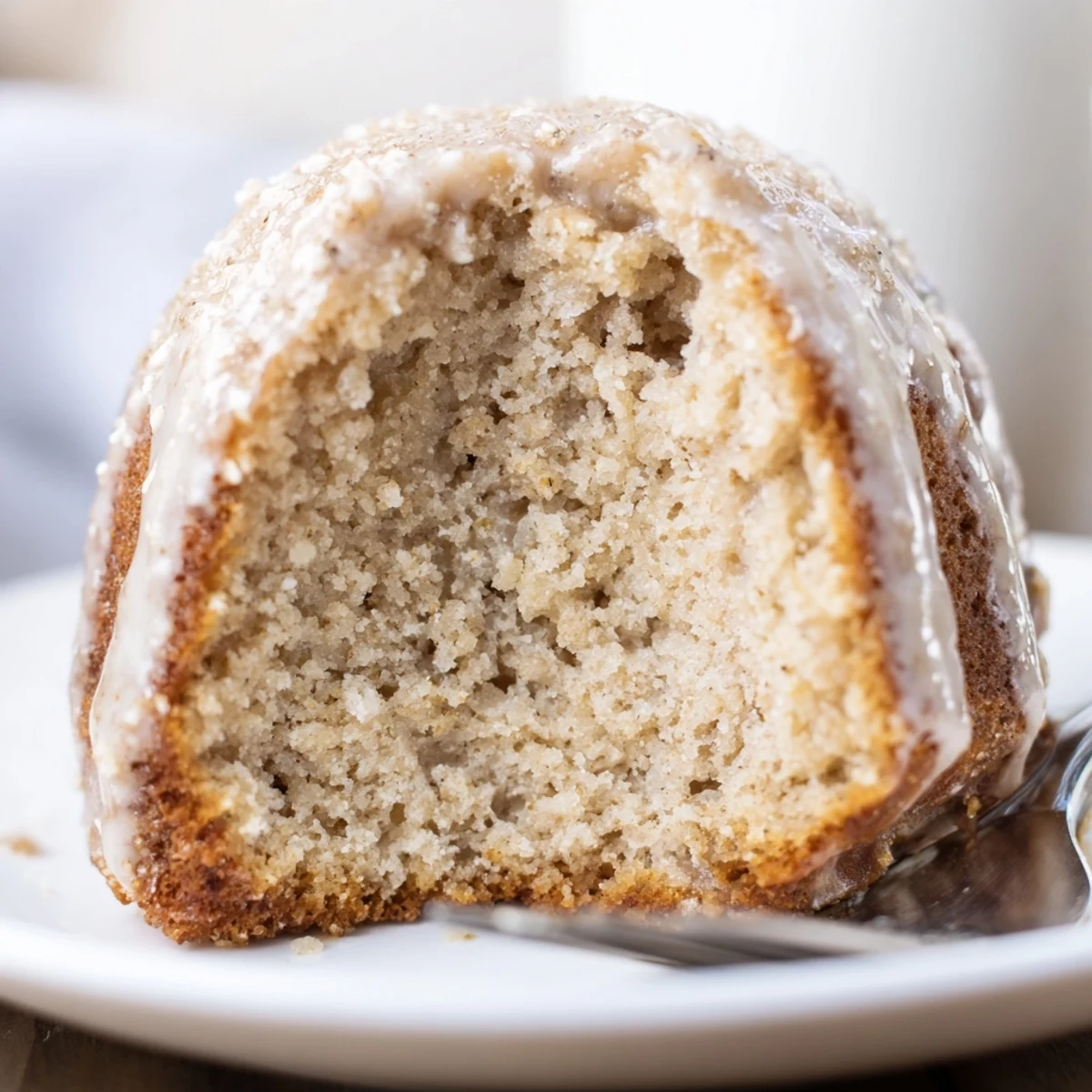 Plated Banana Donuts with powdered glaze, tender crumb, perfect breakfast treat.
