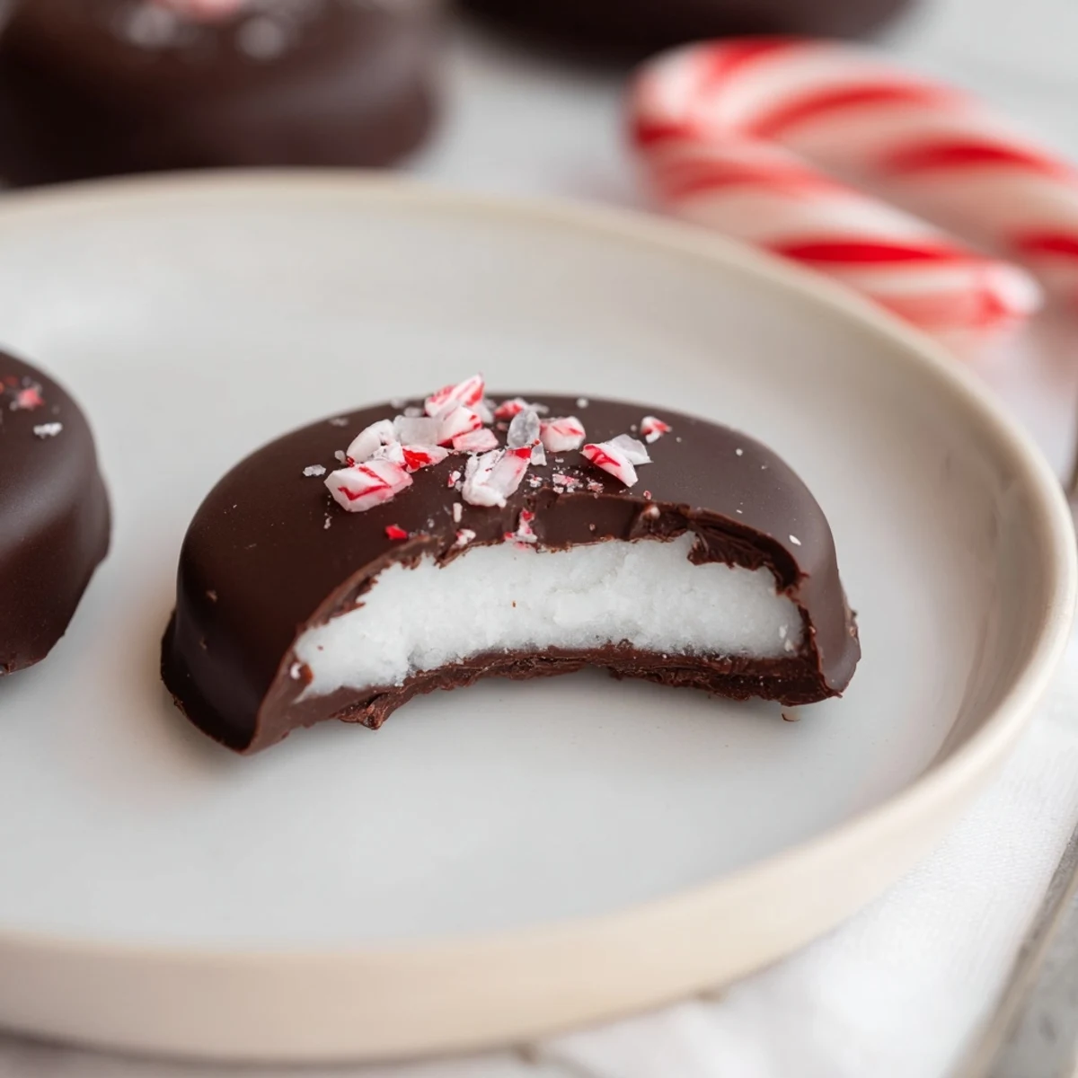 Peppermint Patties chilled on parchment, glossy dark chocolate and minty aroma