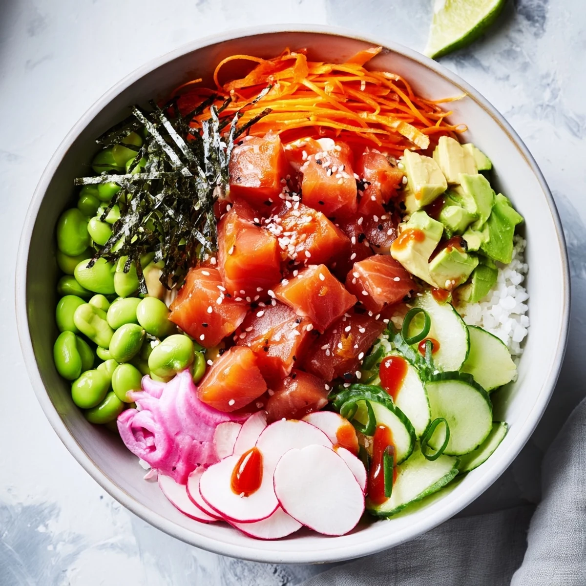 Colorful salmon and avocado poke bowl topped with fresh vegetables and sesame seeds