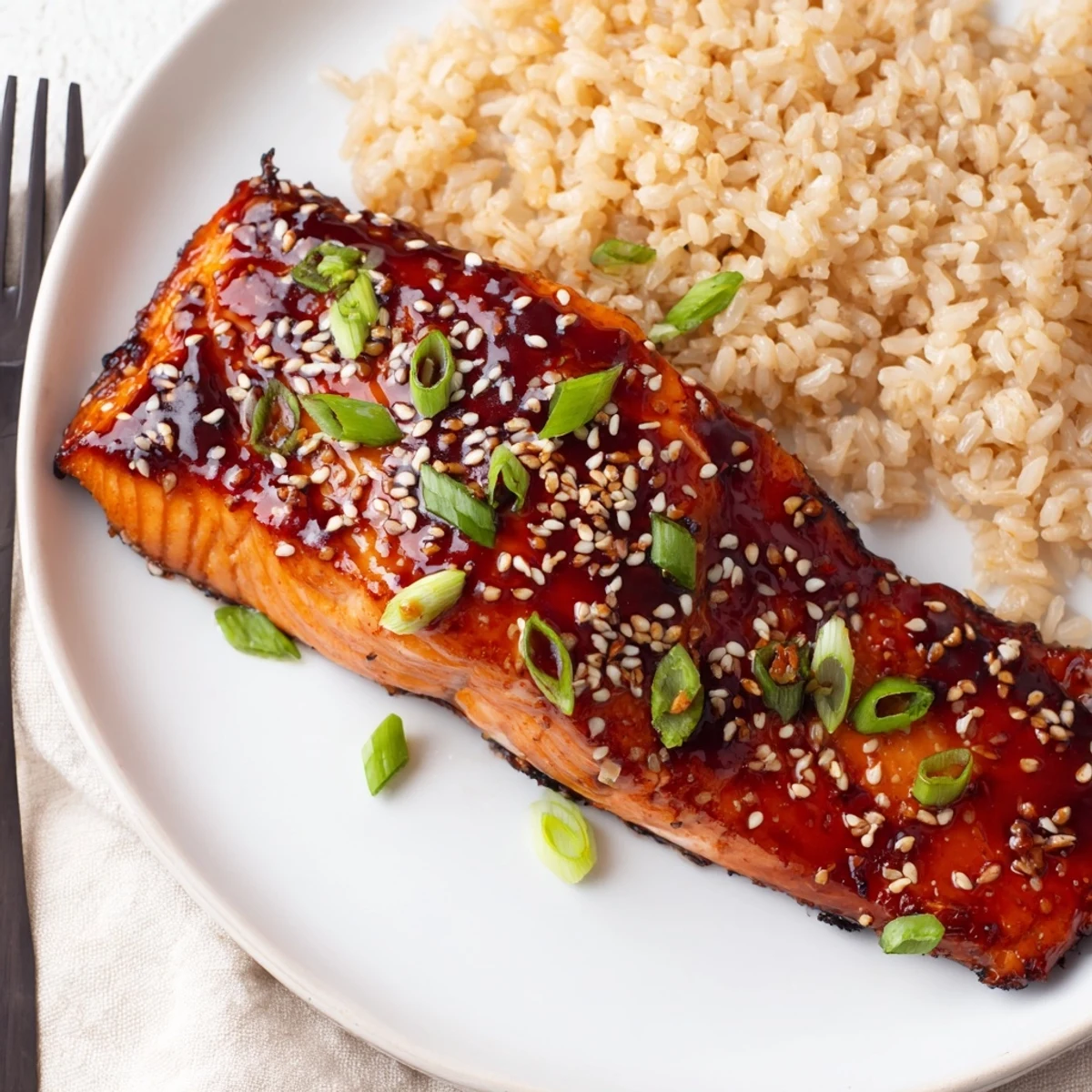 Fork-flaked Baked Teriyaki Salmon steaming on plate, sweet-umami aroma rising