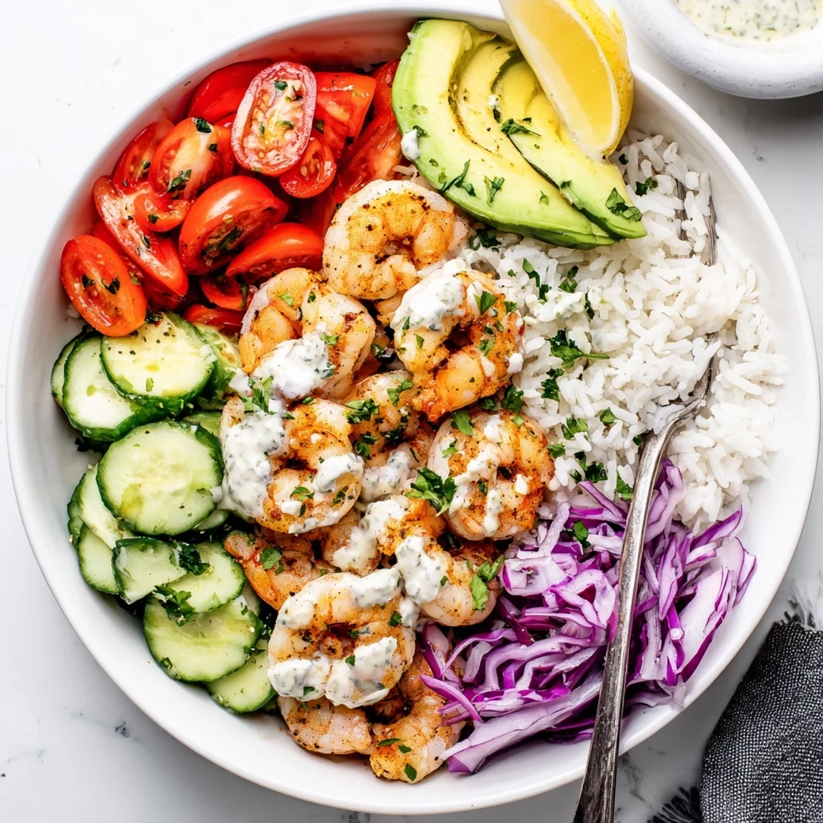 Drizzled with tangy yogurt sauce, this Garlic Shrimp Bowl invites bright citrus