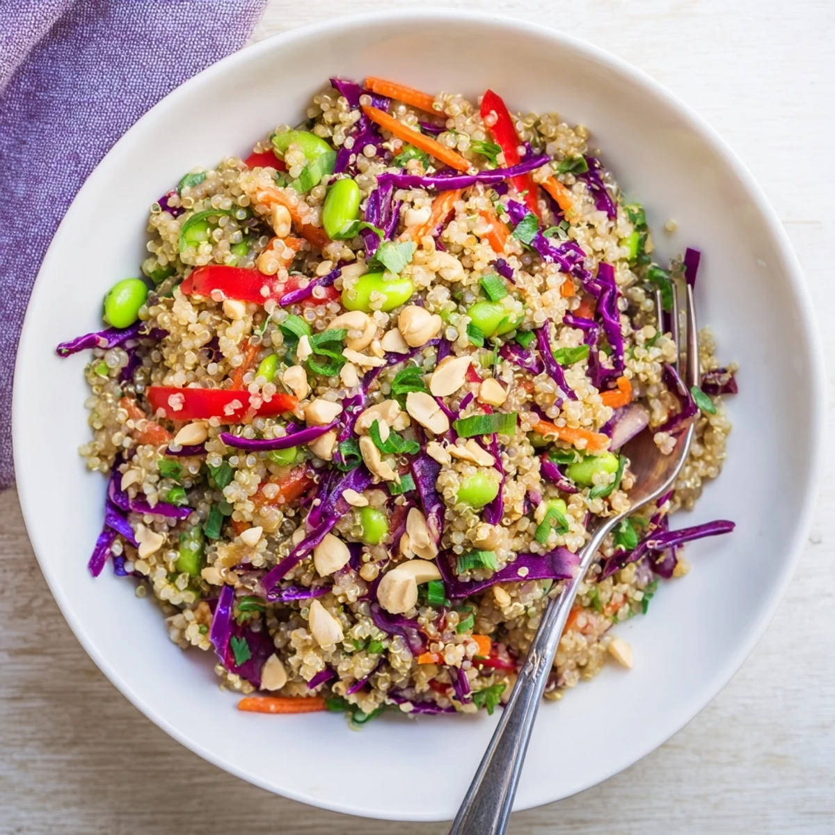 Chilled Asian Dressing Quinoa Salad served in a bowl, sprinkled with chopped peanuts.