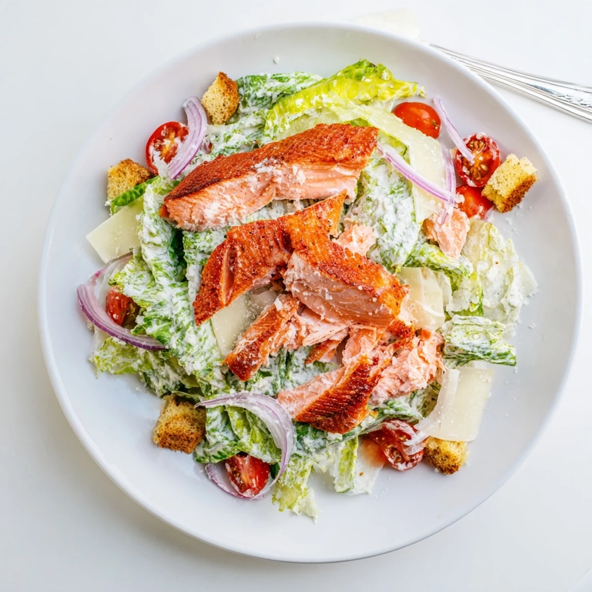 Smoky Salmon Caesar Salad with flaky, smoked fillets, crisp romaine, zesty dressing