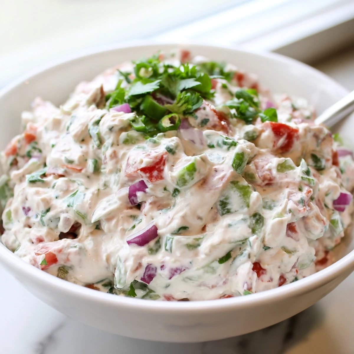 Creamy Grillos Pickle De Gallo Ranch Dip served in a white bowl with tortilla chips