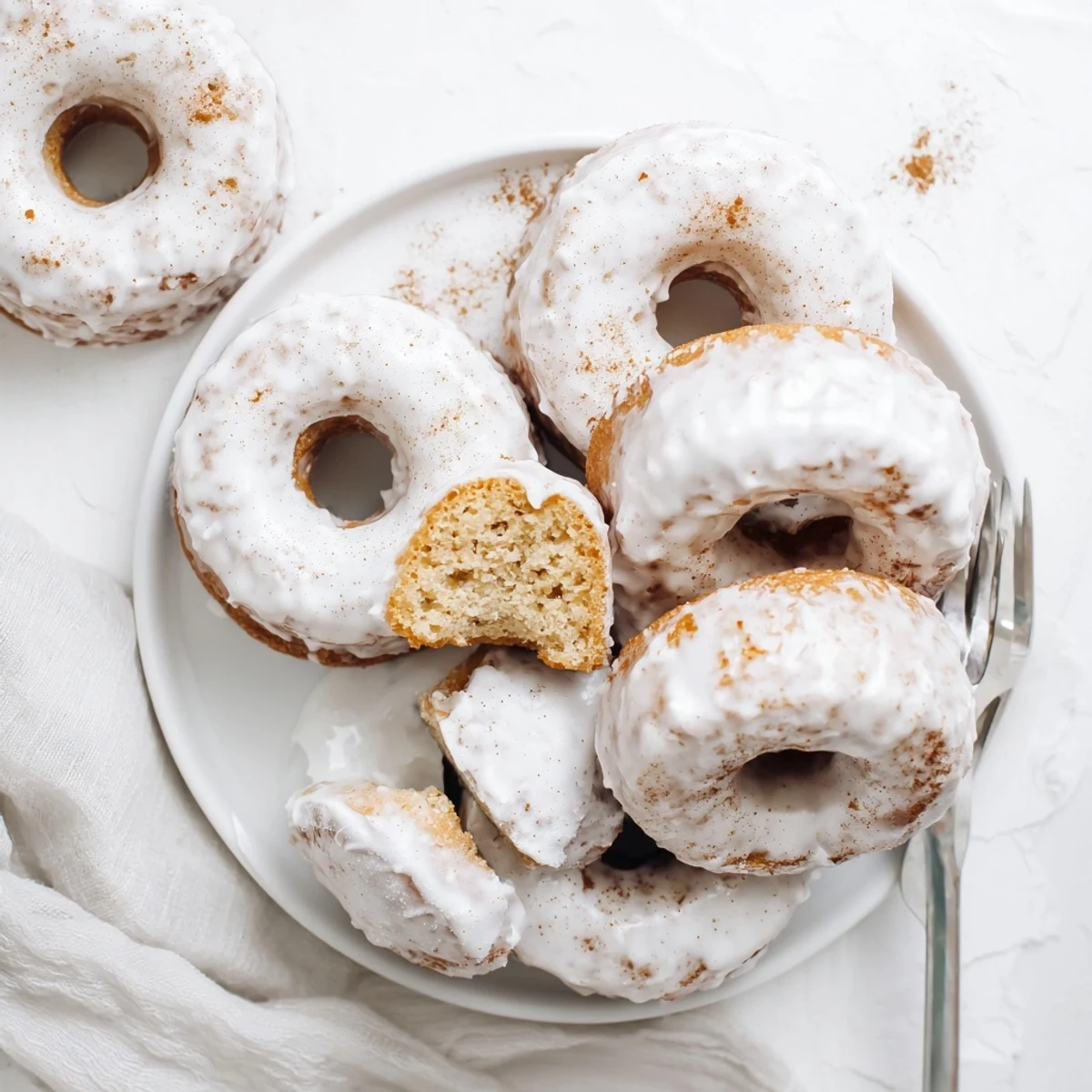 Golden banana bread donuts with sweet vanilla glaze on a wire cooling rack