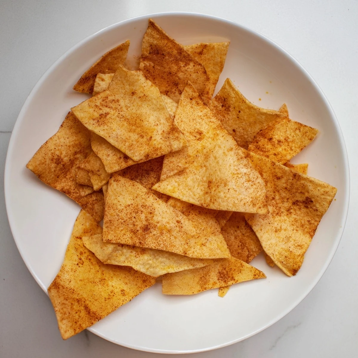 Baked chickpea chips sprinkled with smoked paprika and garlic powder, golden brown and crunchy