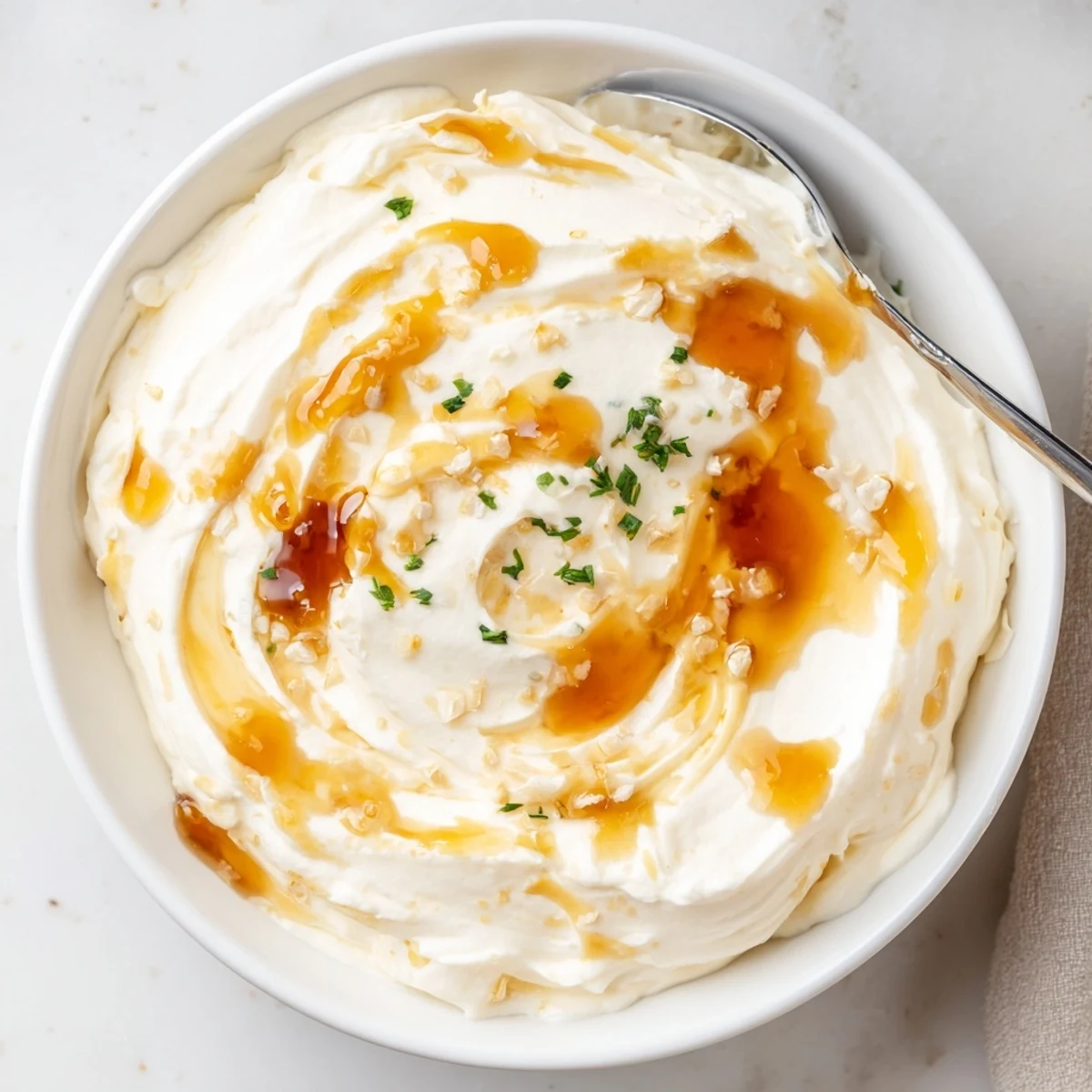 Creamy Hot Honey Ranch Dip chilled in bowl, garnished with fresh chives