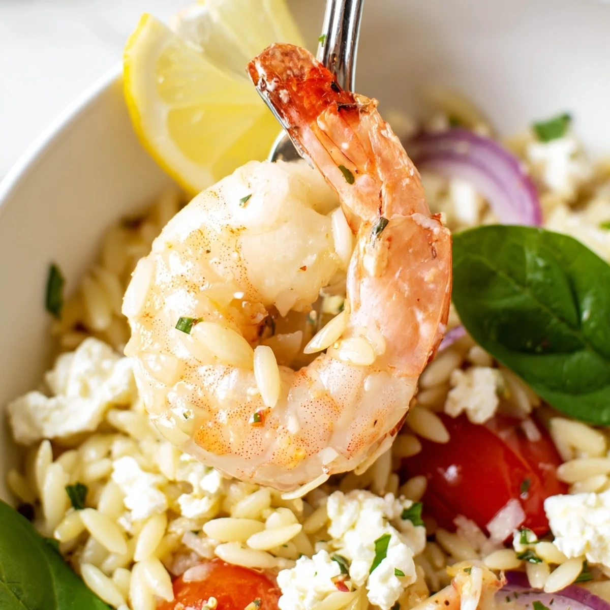 A skillet of Lemon Feta Orzo Shrimp Recipe glistening with olive oil