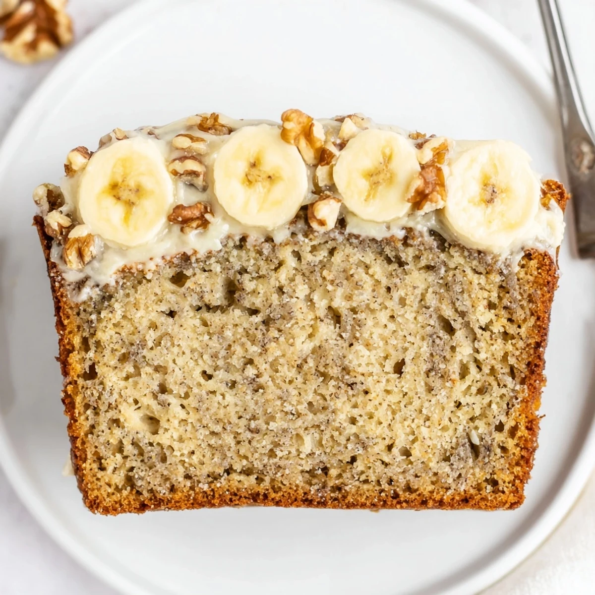 Moist banana cake cooling on wire rack, warm aroma of bananas