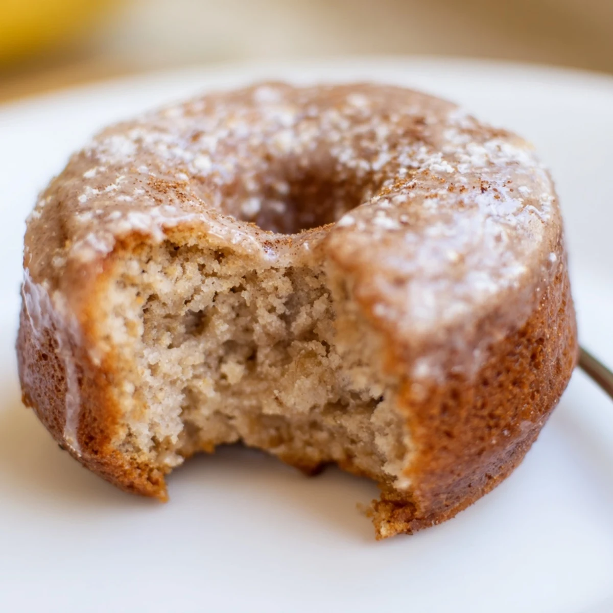 Moist Banana Donuts redolent of cinnamon, cooling on a wire rack.