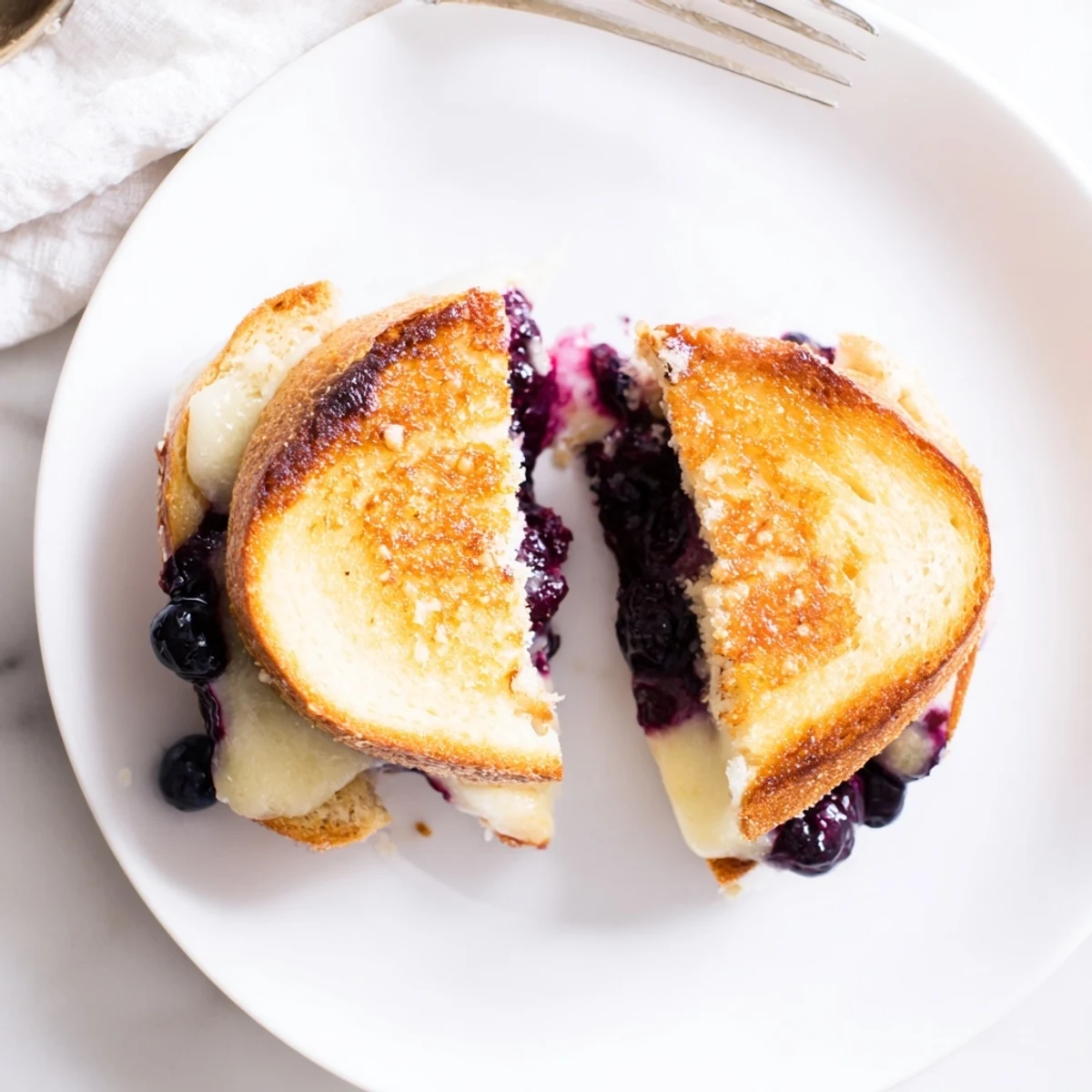 Crispy Blueberry Grilled Cheese with golden crust and melted cheddar oozing