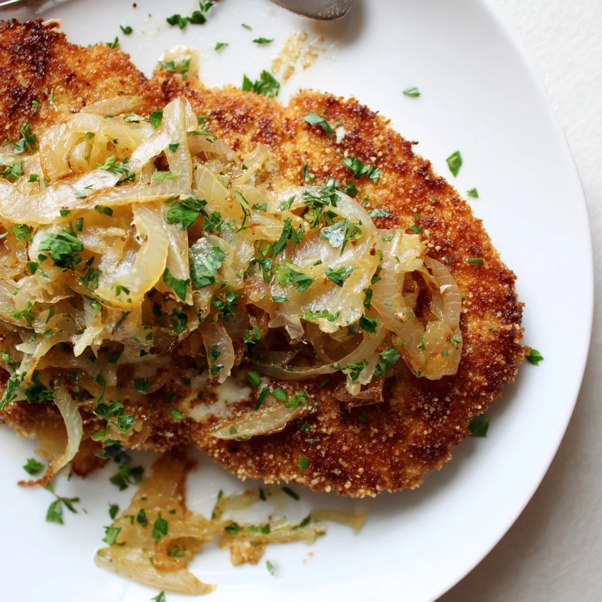 Crispy Chicken Caramelized Onions Melted Cheese on parchment, ready to serve with salad