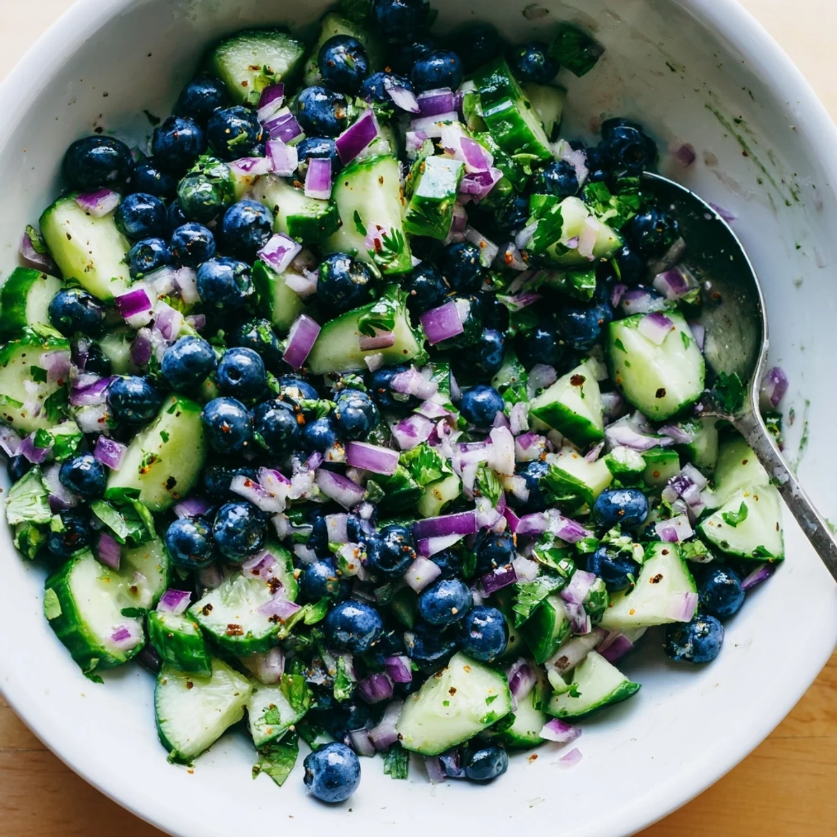 Fresh blueberry cucumber salsa in a bright bowl with tortilla chips nearby