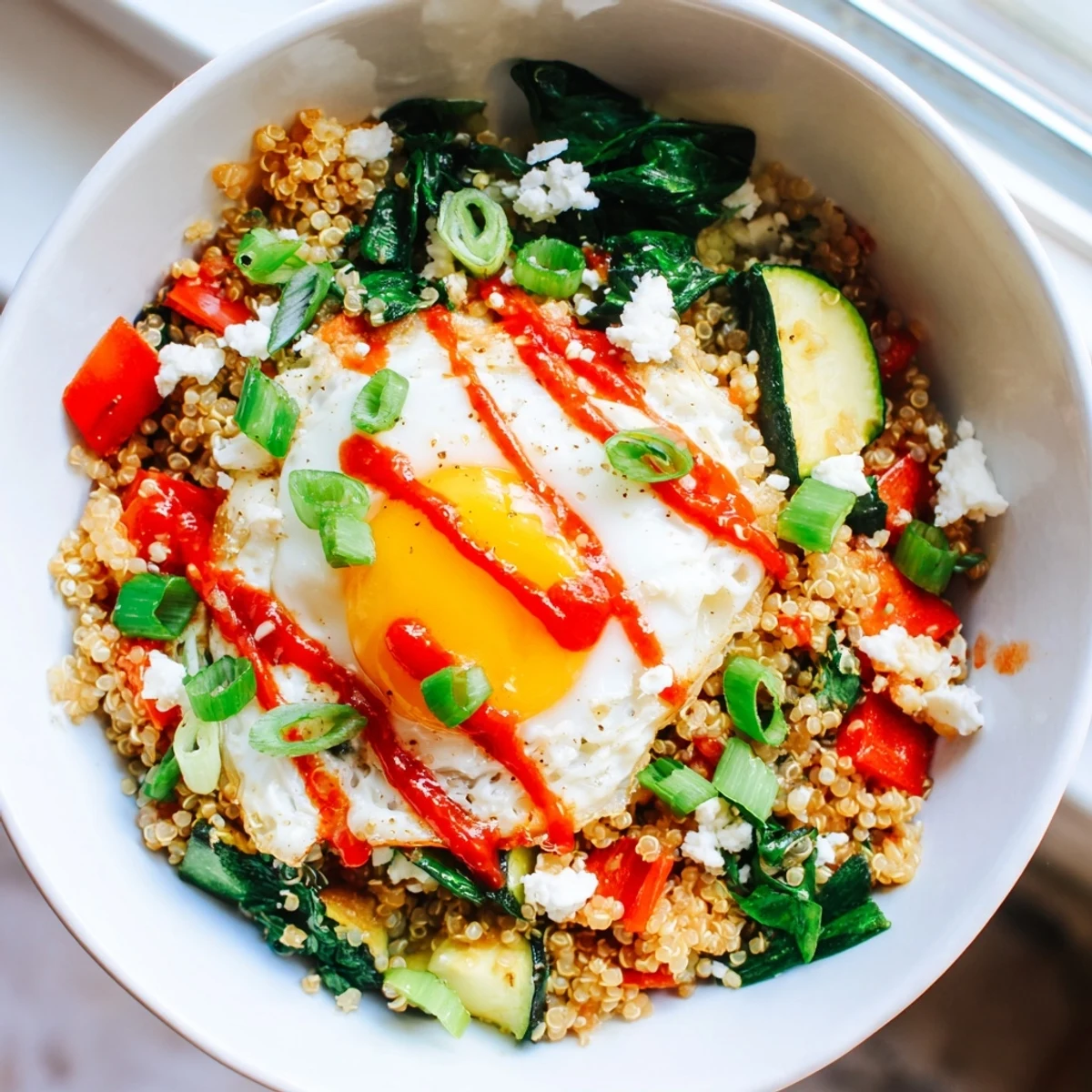 Warm Savory Quinoa Breakfast Bowl loaded with colorful veggies and fresh herbs