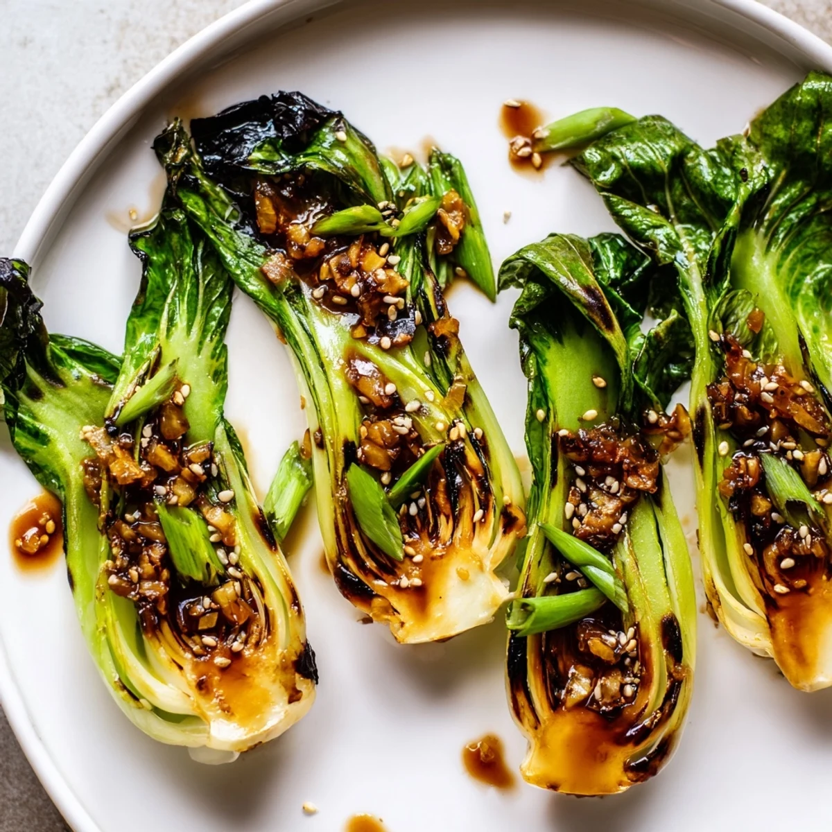 Tender caramelized garlic bok choy glistening with sesame soy glaze and green onions