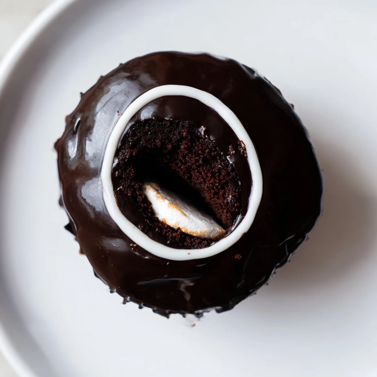Homemade Hostess Cupcakes with glossy ganache and fluffy marshmallow filling