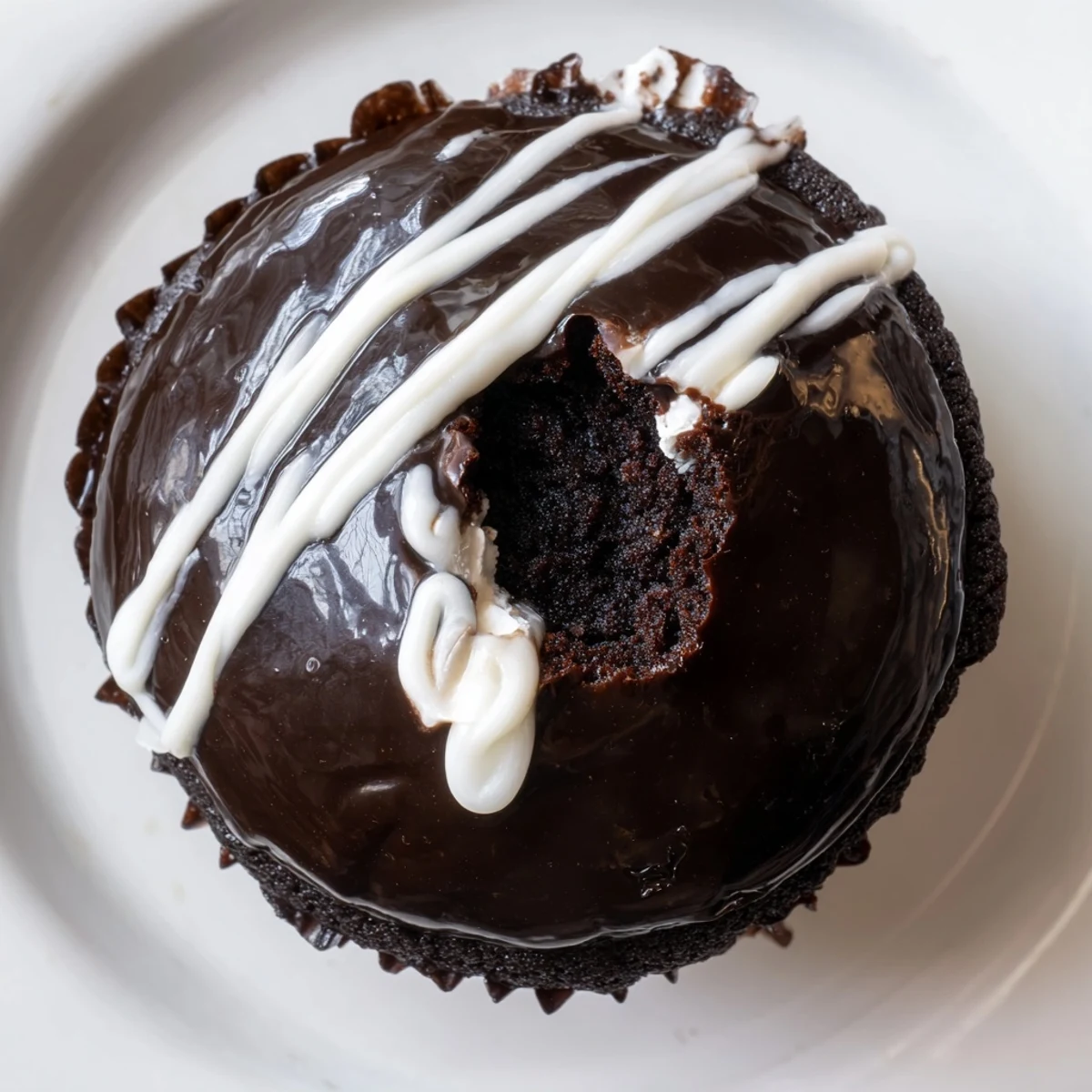 Creamy marshmallow-stuffed Homemade Hostess Cupcakes drizzled with rich chocolate ganache topping
