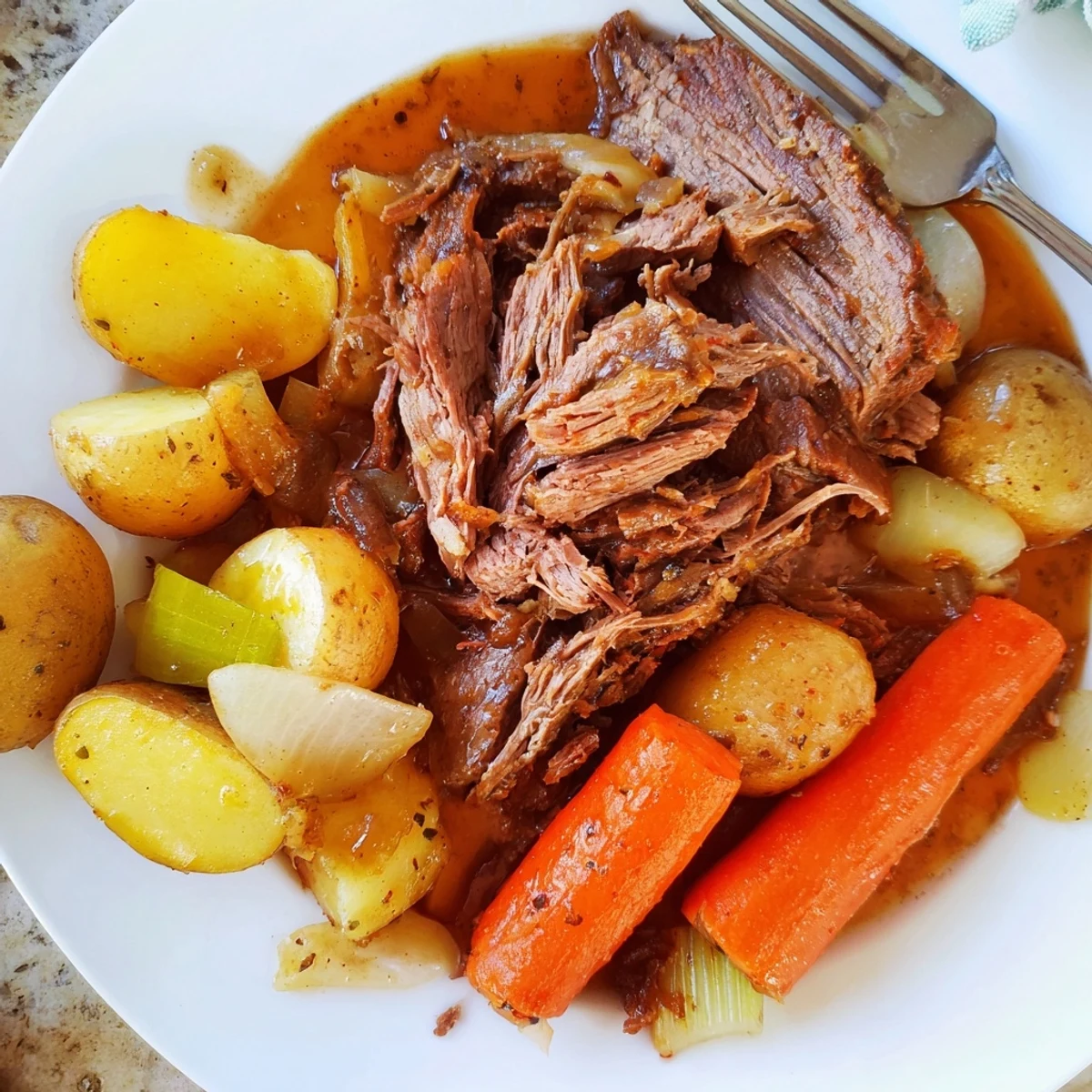 Fork-tender perfect pot roast served in a rustic Dutch oven with root vegetables
