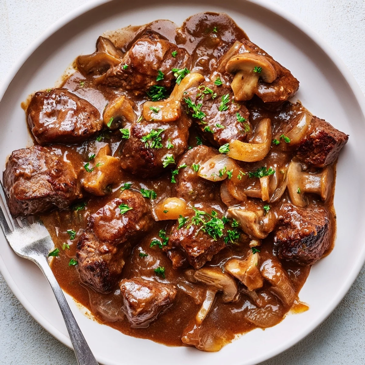 Juicy browned steak tips and gravy in a rich, savory beef broth sauce