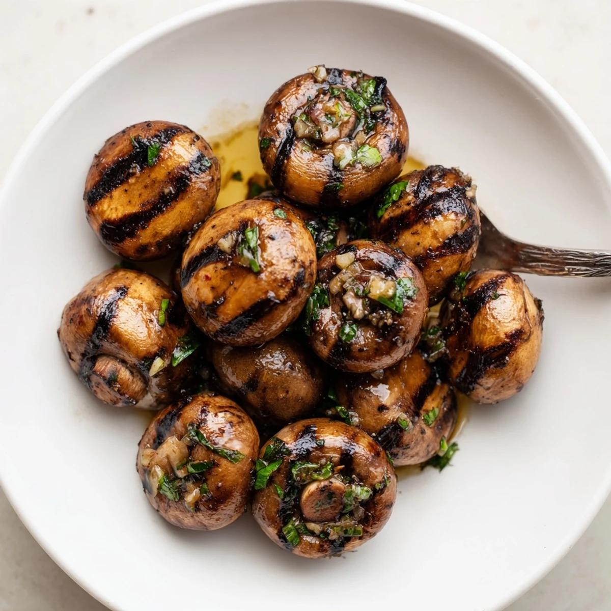 Sizzling steakhouse garlic butter mushrooms with bold grill marks served warm