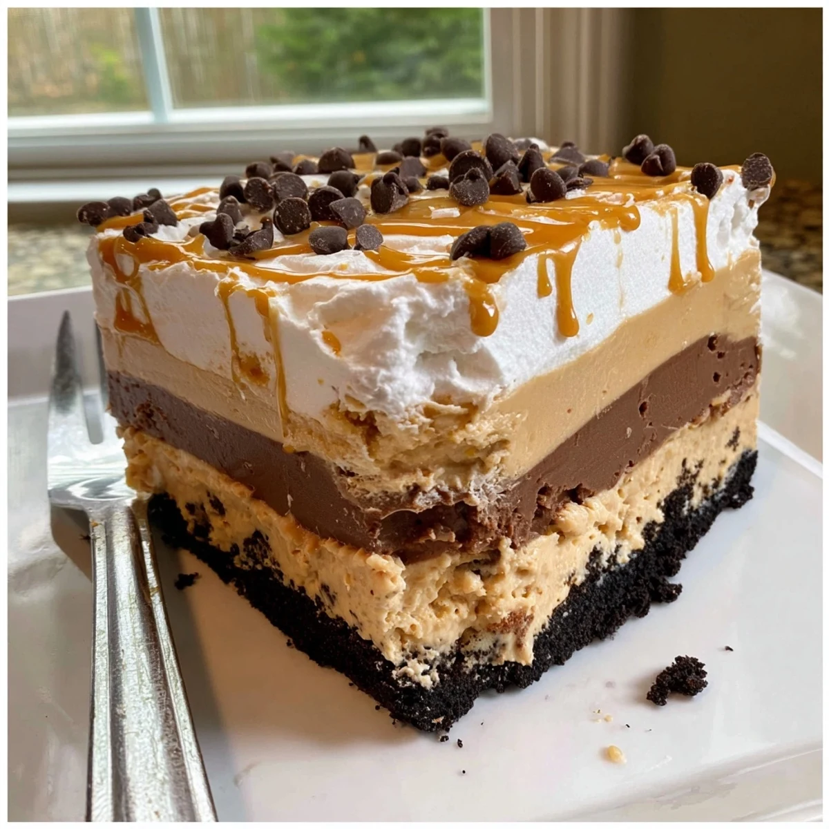 Peanut butter layered delight sliced into squares showing cookie crust and pudding