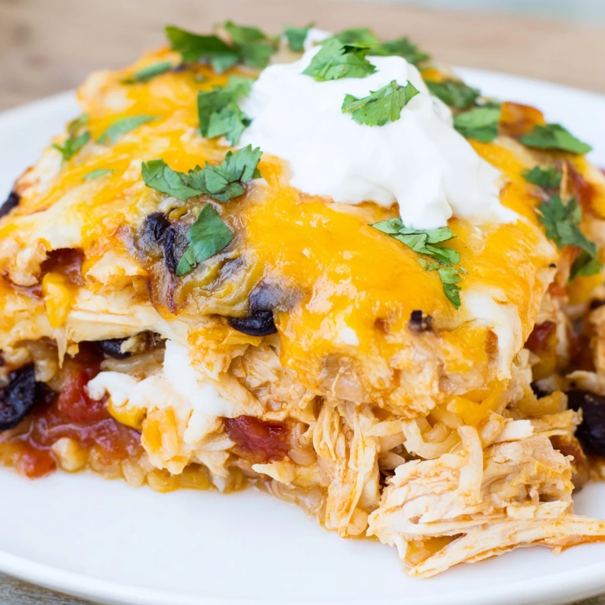 Creamy chicken burrito casserole bubbling with salsa and melted Mexican cheese blend