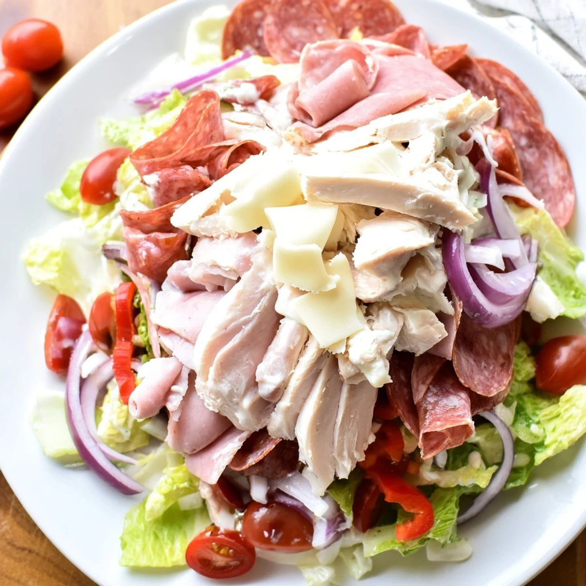 Hearty Italian grinder chicken salad loaded with sliced meats and fresh vegetables.