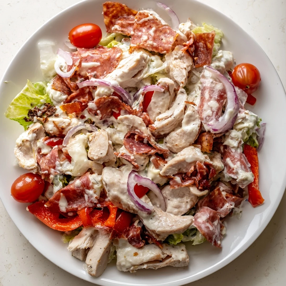 Warm sliced chicken over a crisp Italian grinder chicken salad with pepperoncini.