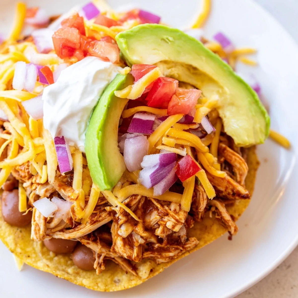Golden crispy Chicken Tostadas loaded with seasoned meat and fresh colorful toppings  