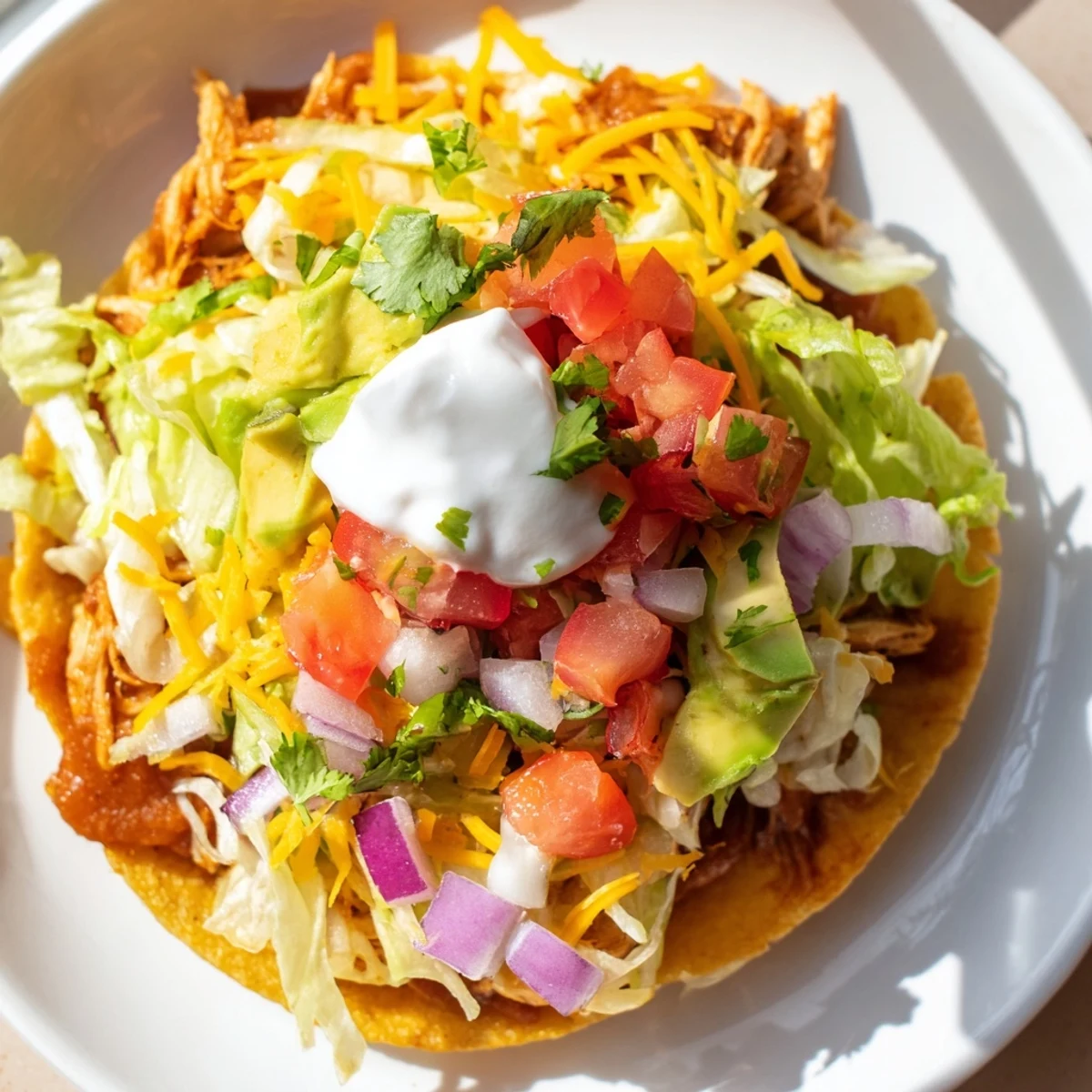 Crispy corn tortillas topped with seasoned chicken, vibrant veggies, and sour cream.  