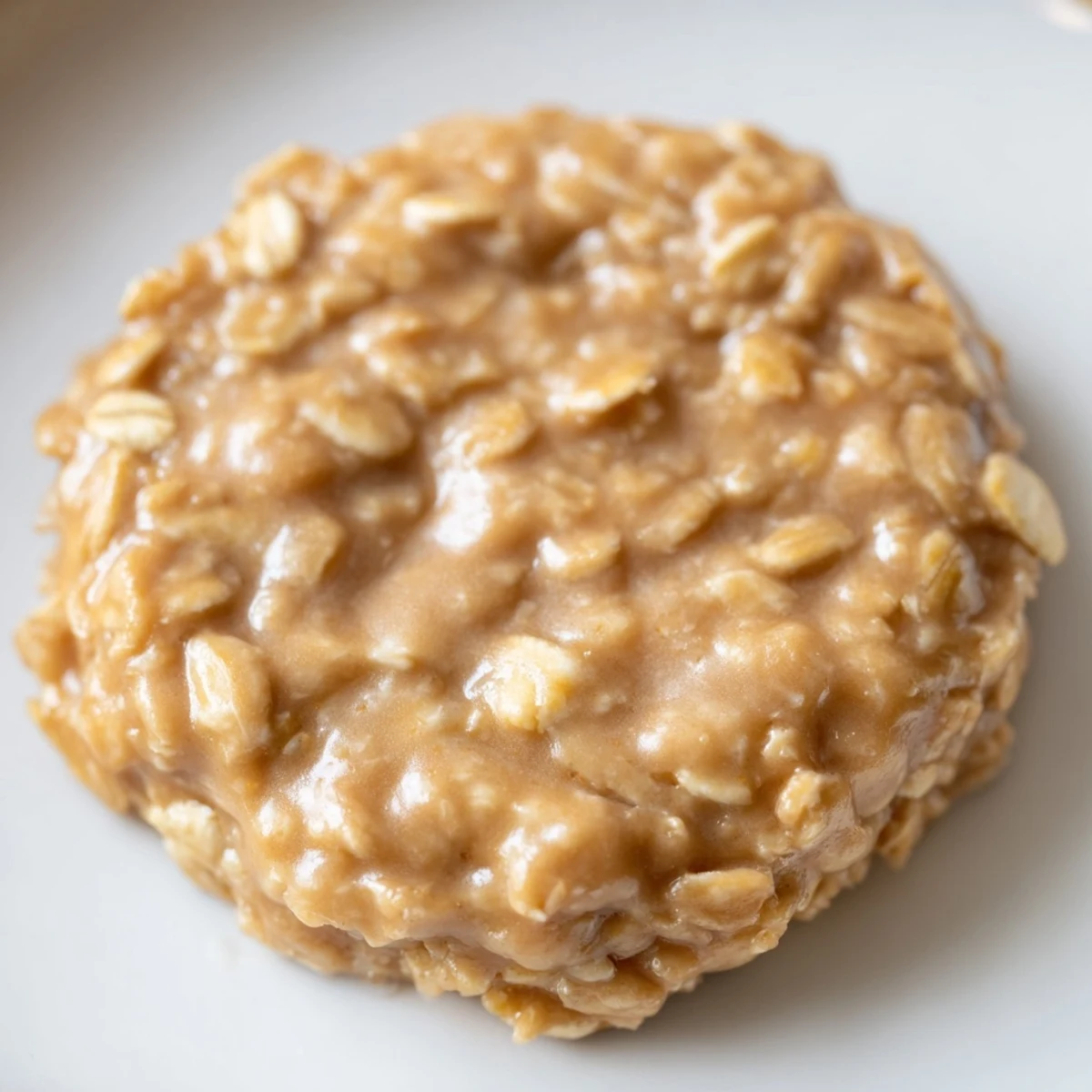 Stacked peanut butter no bake cookies with oats cooling on a wire rack.  