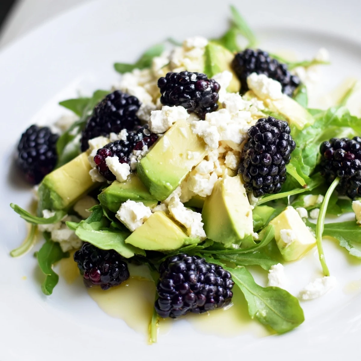 Refreshing blackberry avocado salad featuring sweet berries, crisp greens, and tangy lime dressing