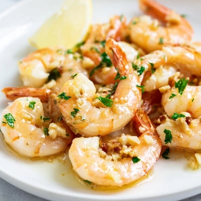 Sizzling buttered shrimp tossed in lemon garlic butter served in a cast iron skillet